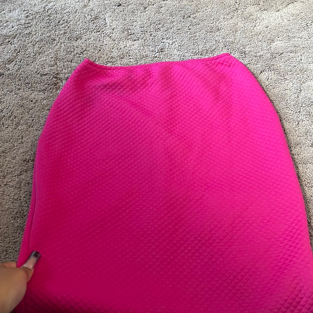 Color: hot pink. Material: felt kind of texture, stretchy, curve fitting